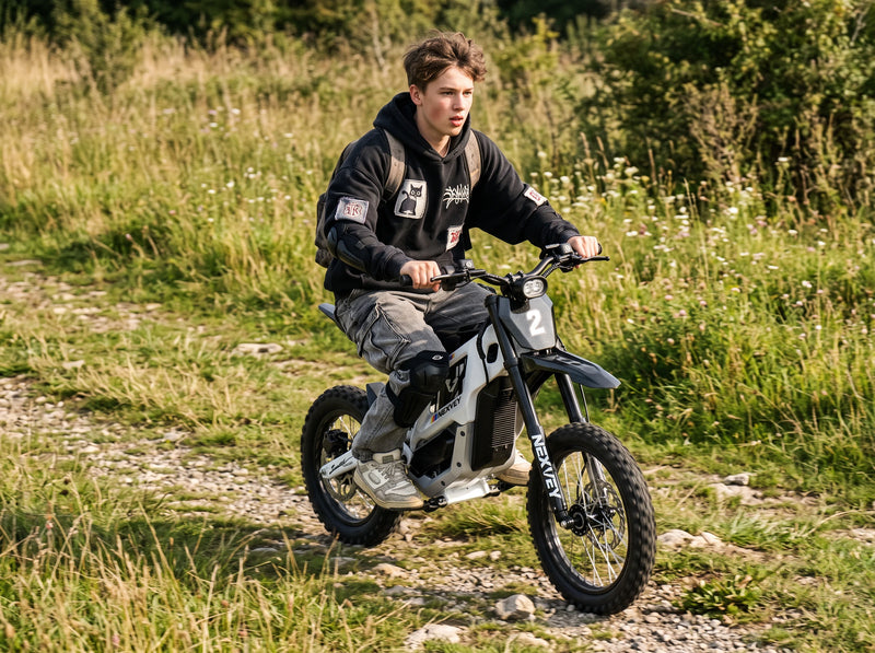 A rider on a white NEXVEY FLASH 2 electric dirt bike on a grassy gravel trail