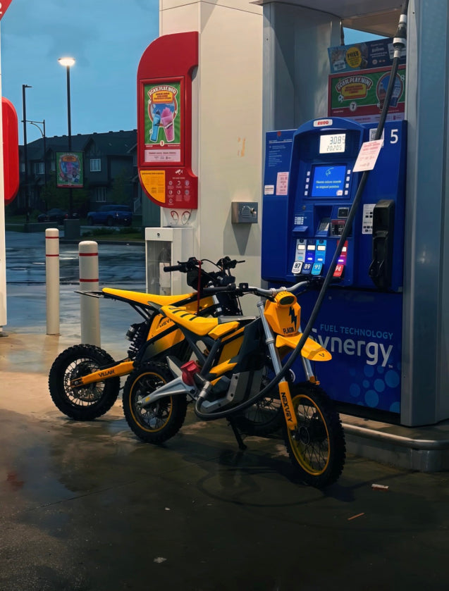 Yellow NEXVEY Flash electric dirt bike at an electric charging station