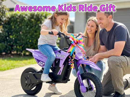 A young girl on a Nexvey Spark 02 purple electric dirt bike with a rainbow bow, presented as a gift by smiling parents.