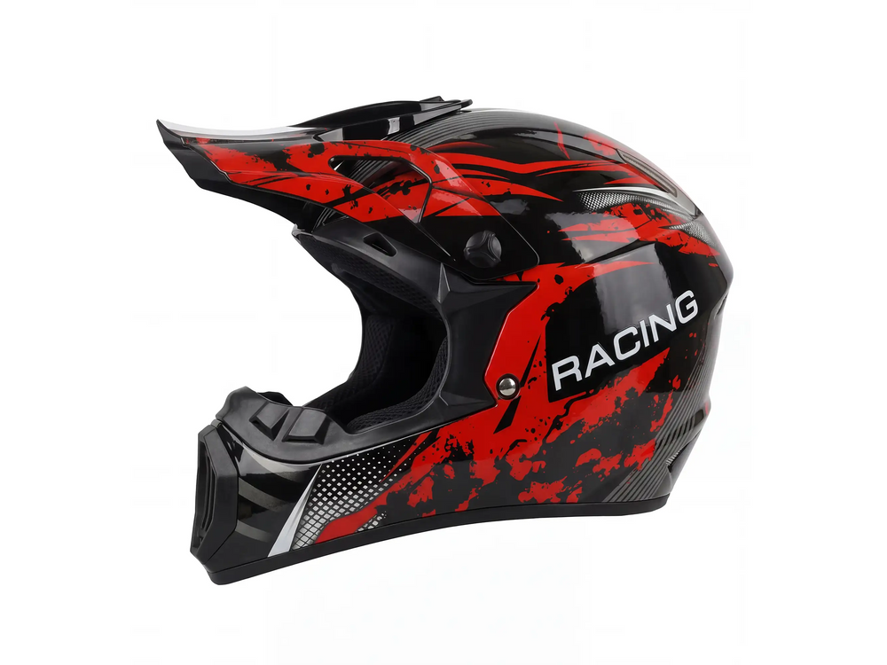 Side view of a black and red full face motocross helmet with aggressive splash graphics, a sun visor, and "RACING" text, isolated on a white background for an off-road racing gear product listing