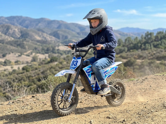 Young boy wearing a full-face helmet riding a Nexvey Spark 03 electric dirt bike on an off-road mountain trail