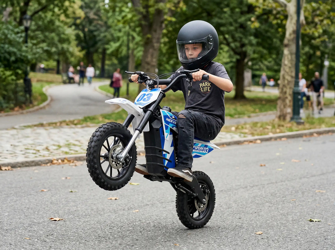 Action shot of a young boy performing a wheelie on a Nexvey Spark 03 electric dirt bike for kids in a park